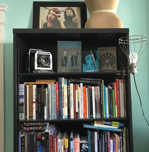 Atop her bookcase is a photo Colleen Woolpert took of herself and sister Rani when Colleen lived in the apartment above 20 years ago in 2001.