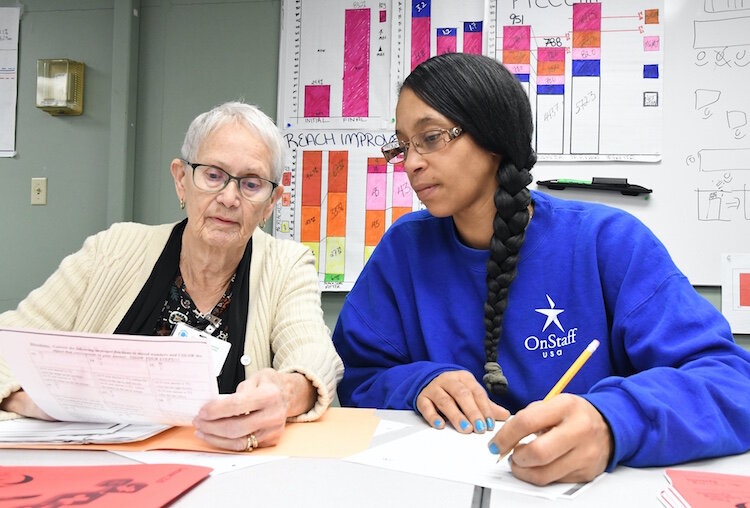 Carol Poole, GED instructor for Battle Creek Public Schools, works with Lilleana Bottom, Denso temporary employee, on Mathematics work.