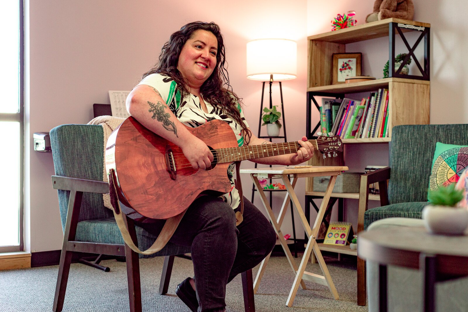 Hannah Joseph, music therapist and social worker at Kalamazoo Child and Family Counseling Plays instruments and sings for her patients.