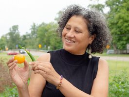 Dr. Michelle Johnson, Playgrown CEO, is seen here with a tomato and a pepper.