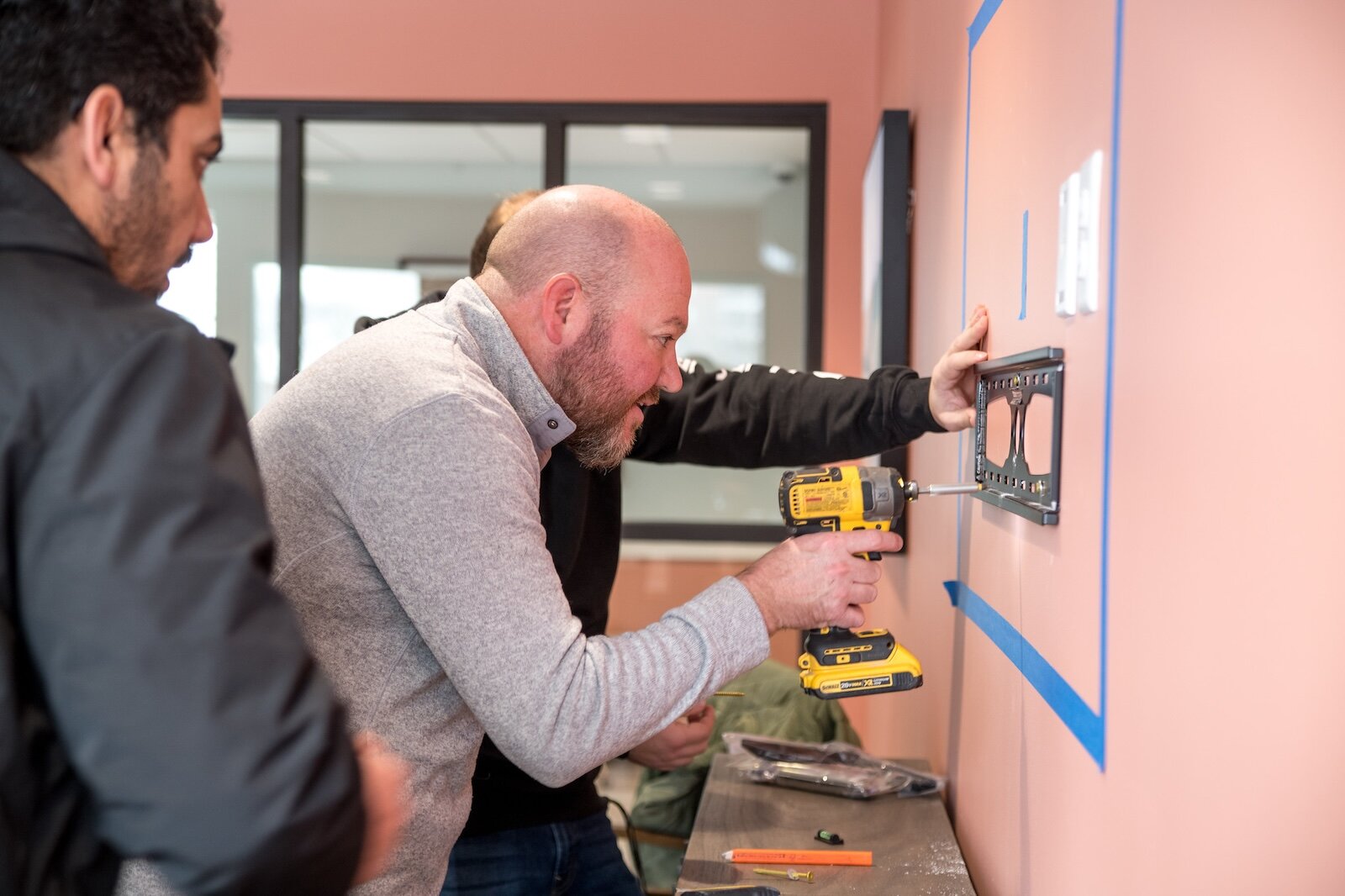 Building owner Garrett Seybert, works on the installation of TVs in the common rooms which are on each floor.