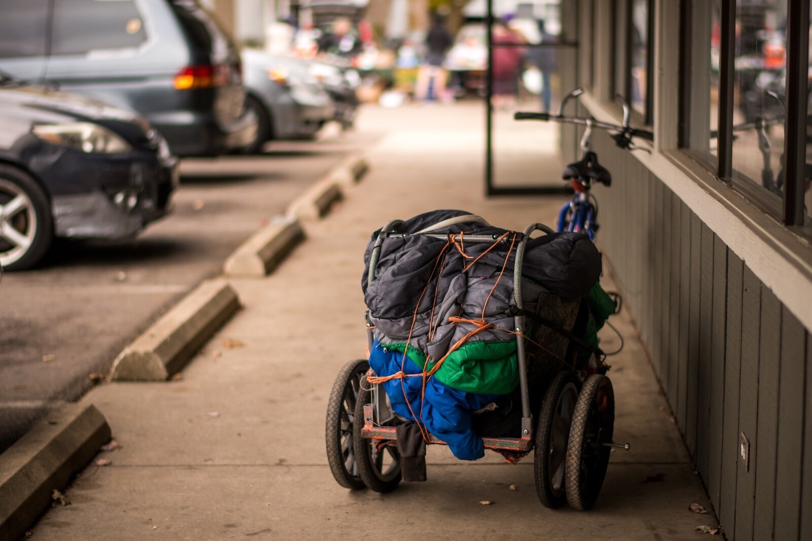 A bike trailer loaded with laundry.