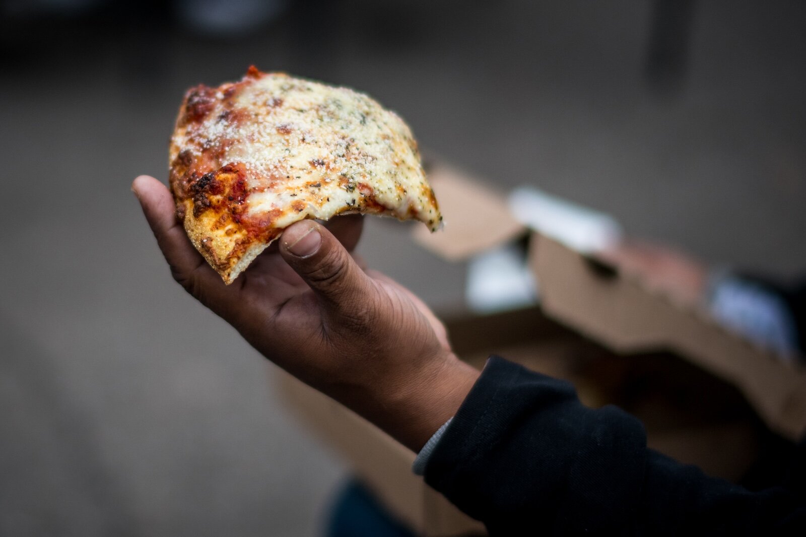 "G" eats pizza as he waits to do his laundry. "You waste so much energy trying to get the basic stuff done, you can't get nothing else done," G says about not having a secure place to live.