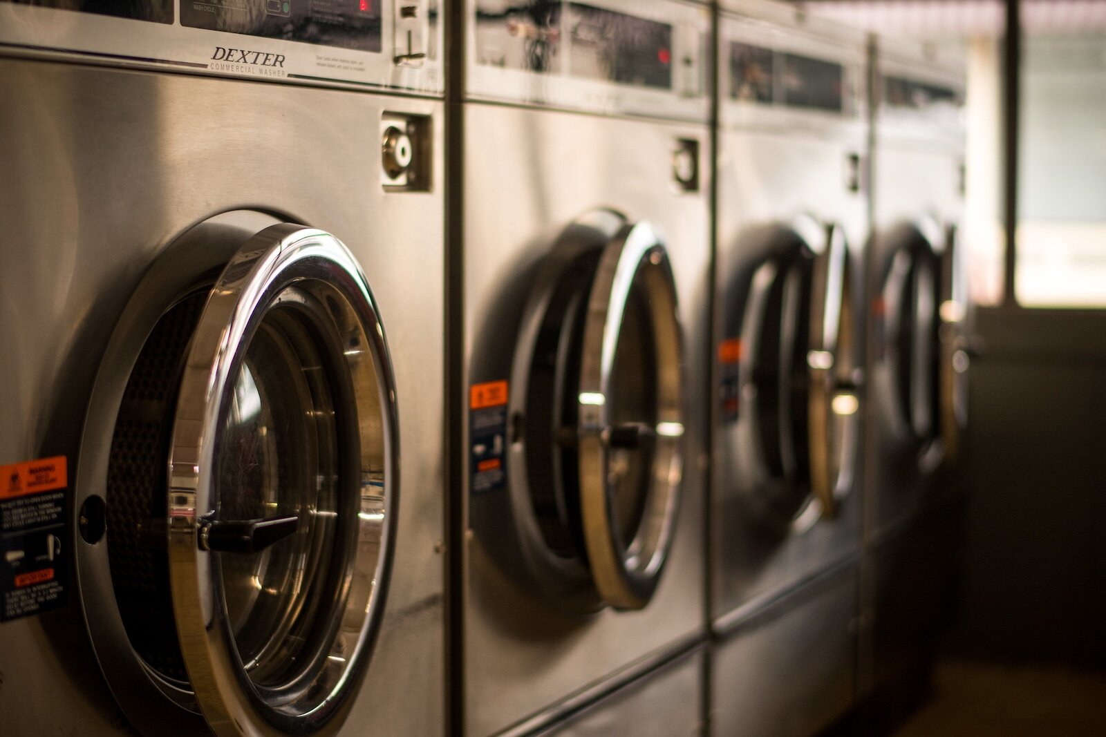 Washing mahines stand ready for laundry day offered through Kalamazoo Together for the Unhoused.