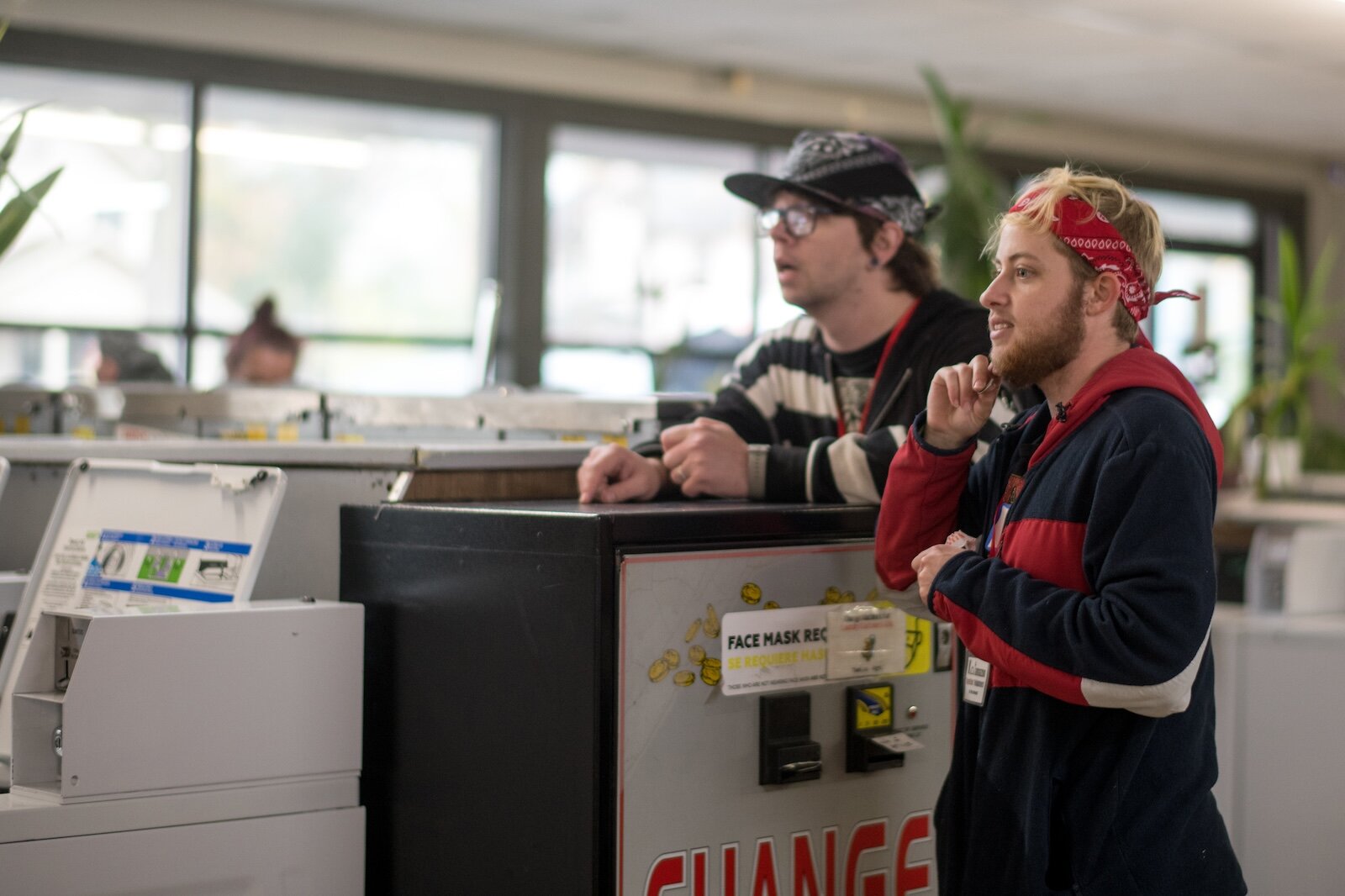 Aiden Aldrige and Chase Platte volunteer to assist with laundry day for the unhoused at the laundromat in the Vine neighborhood.