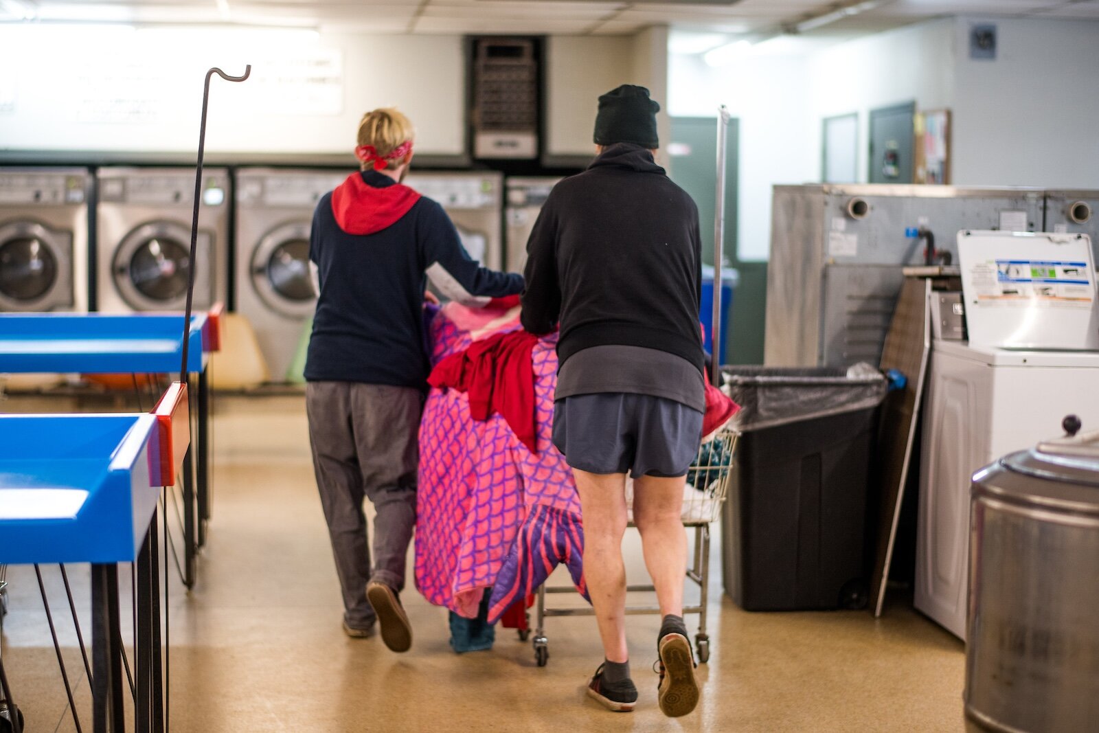 Aiden Aldrige volunteer at laundry day for the unhoused at the laundromat in the Vine neighborhood.