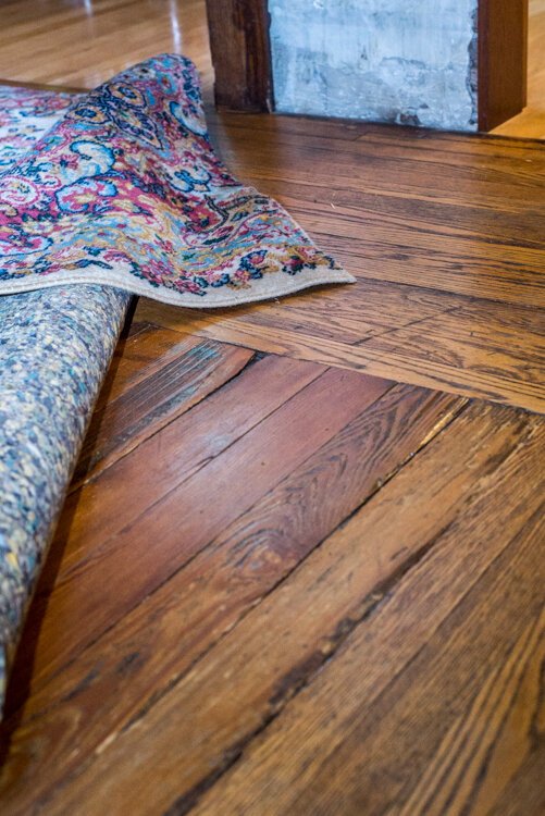 Older homes typically used more expensive wood on the outside of the floors and less expensive wood on the inside. where rugs would often cover it.