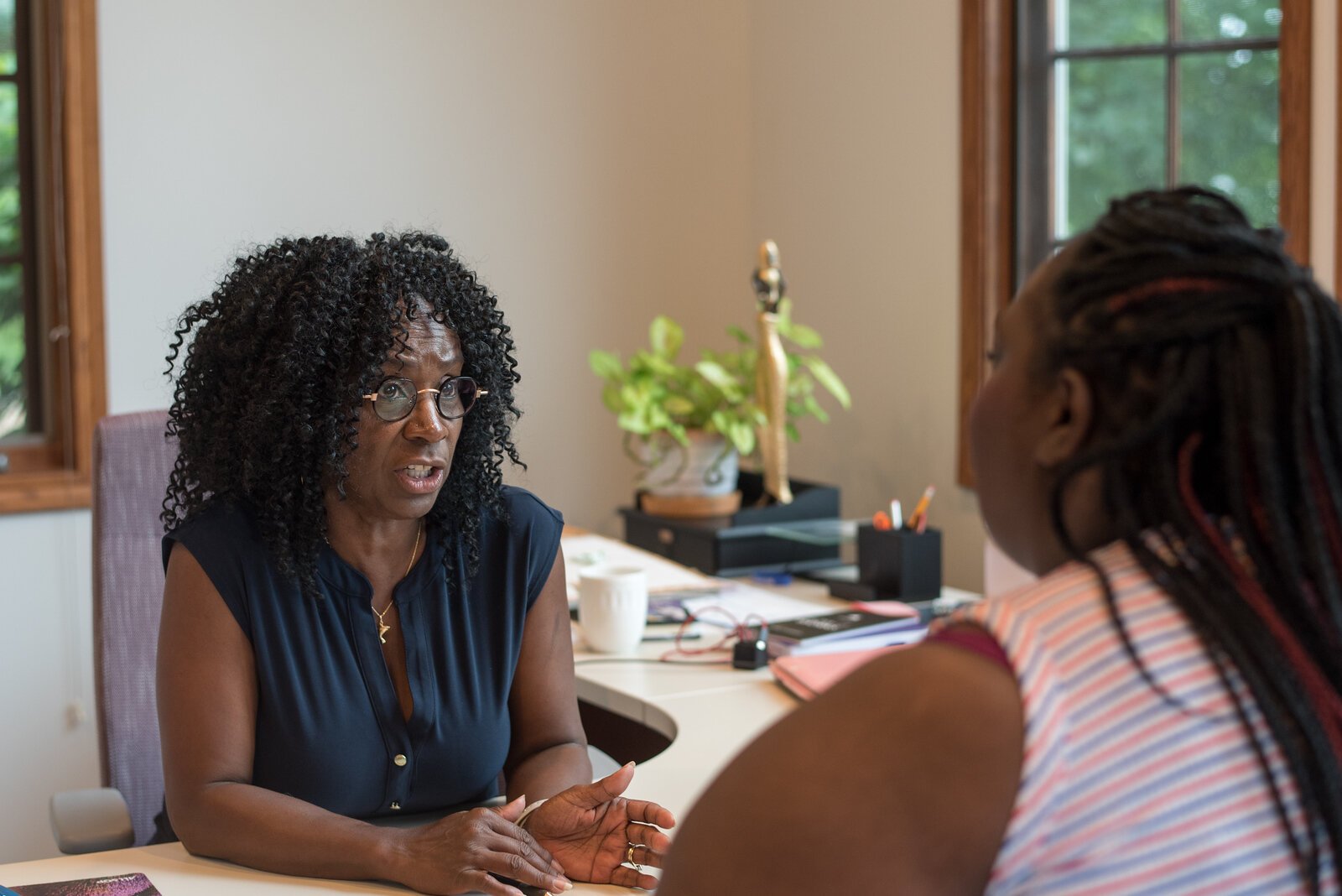 Pam Coffey, Executive Director of Healthy House for Women, speaks to resident Willesha Riddle