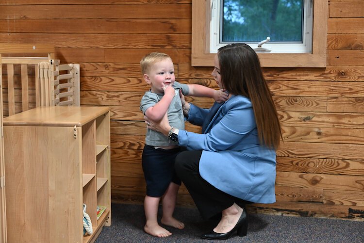 Liz Van Dussen, human resource manager at Battle Creek Duncan Aviation, drops off her 2-year-old son Cade at Bright Light Early Learning and Care before heading to work.