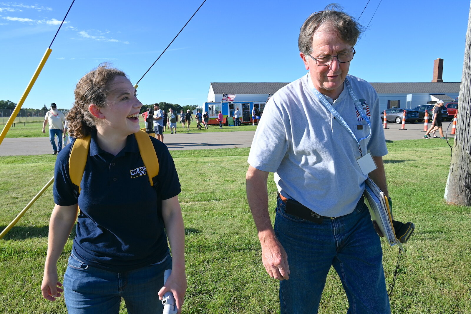 Meteorologist Katie Nickolaou walks with balloon pilot Pat Rolfe following a briefing