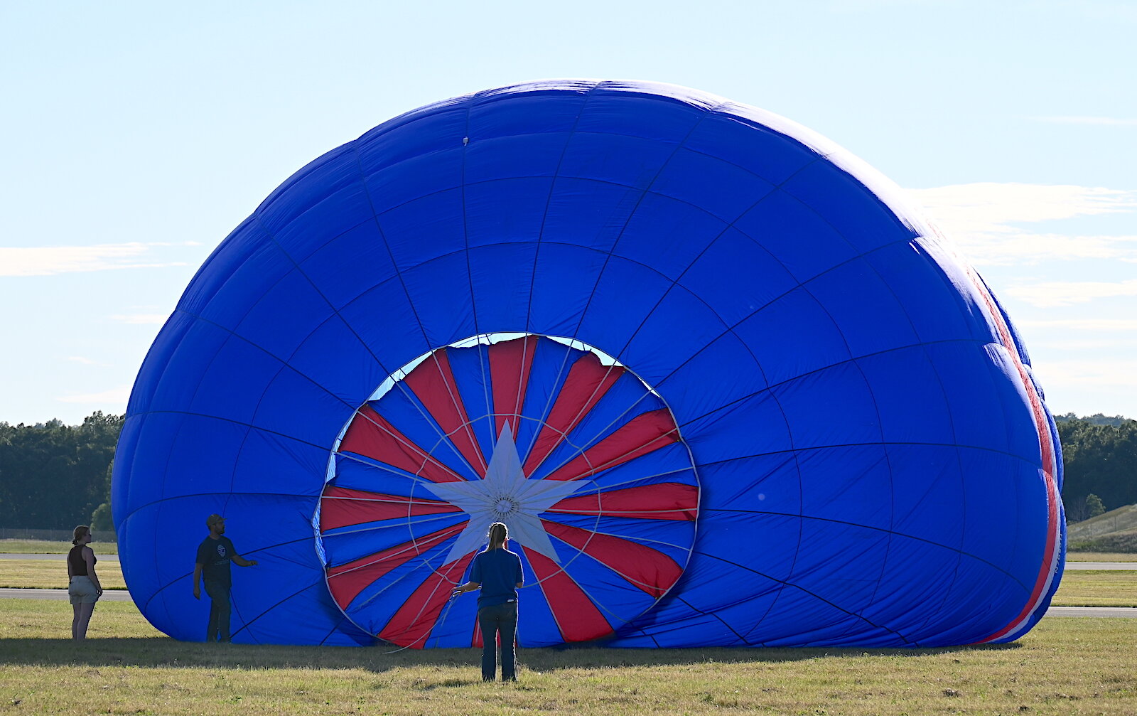 Pilots, their teams, and their balloons prepare and take flight on the evening of July 3.