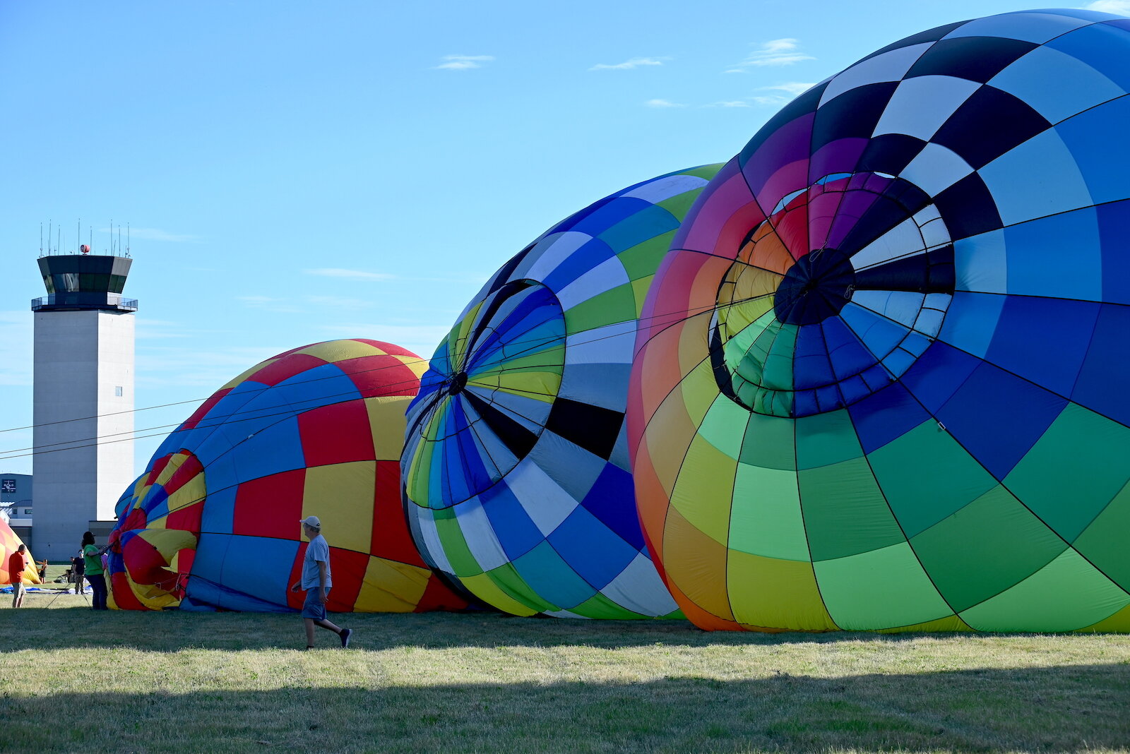 Pilots, their teams, and their balloons prepare and take flight on the evening of July 3.