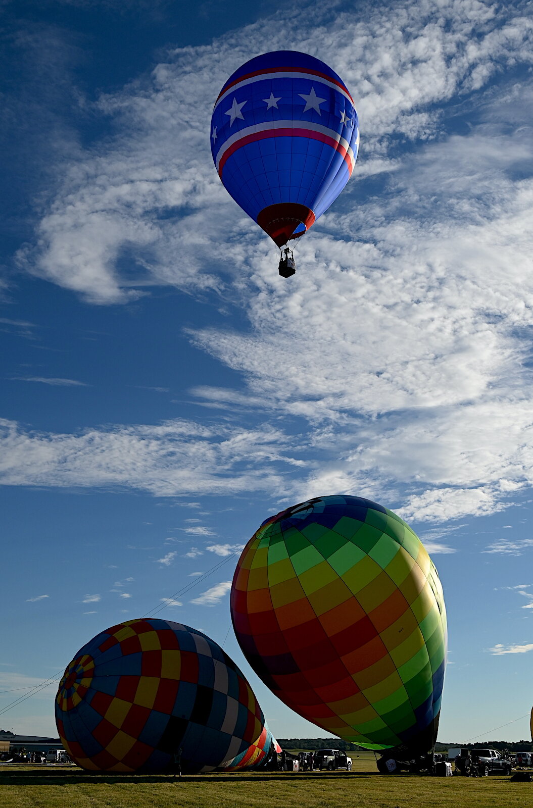 Pilots, their teams, and their balloons prepare and take flight on the evening of July 3.