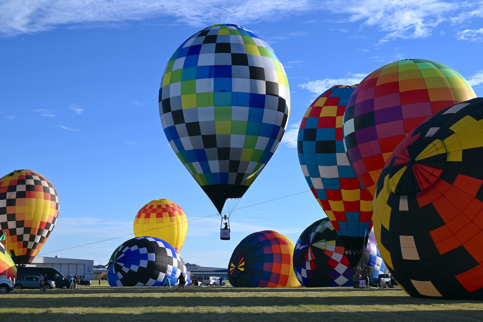 Pilots, their teams, and their balloons prepare and take flight on the evening of July 3.