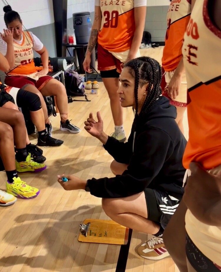 Head Coach Felicia Nokia Thomas huddles with her team during a recent game in Kalamazoo.