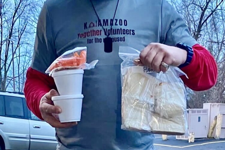 Volunteers with Kalamazoo Together for the Unhoused have a meal train that distributes soups, fruits, sandwiches, and other items.