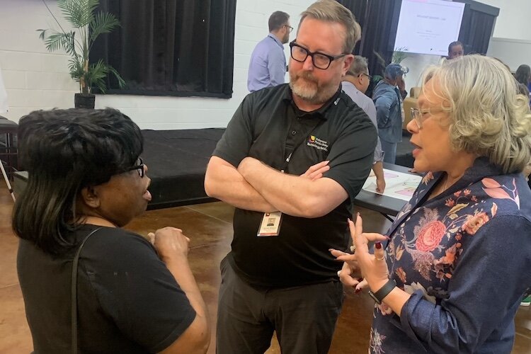 Mattie Jordan-Wood, former executive director of the NACD, left, speaks with the Kalamazoo Public Library’s Jarrod Wilson and Ida Robinson at the Oct. 29, 2024 town hall meeting at NACD.