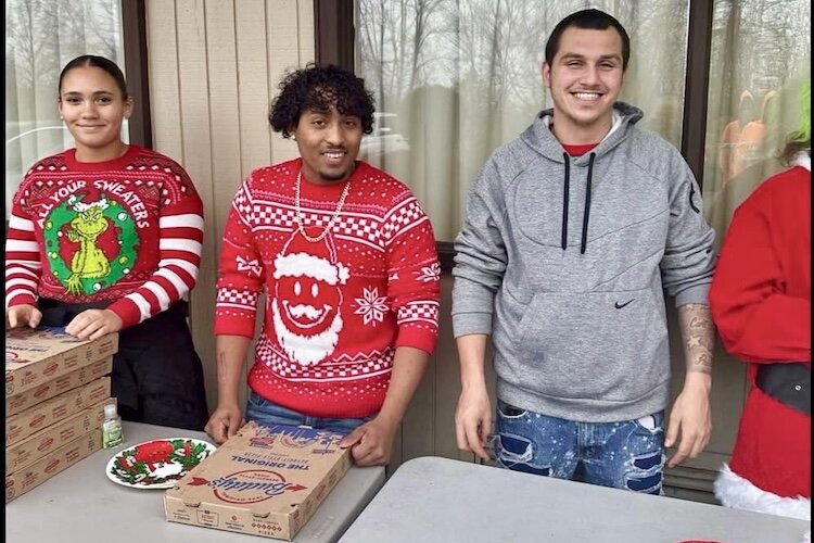 Volunteers are shown preparing to distribute meals at the 2023 Heads in Beds at Christmas event.