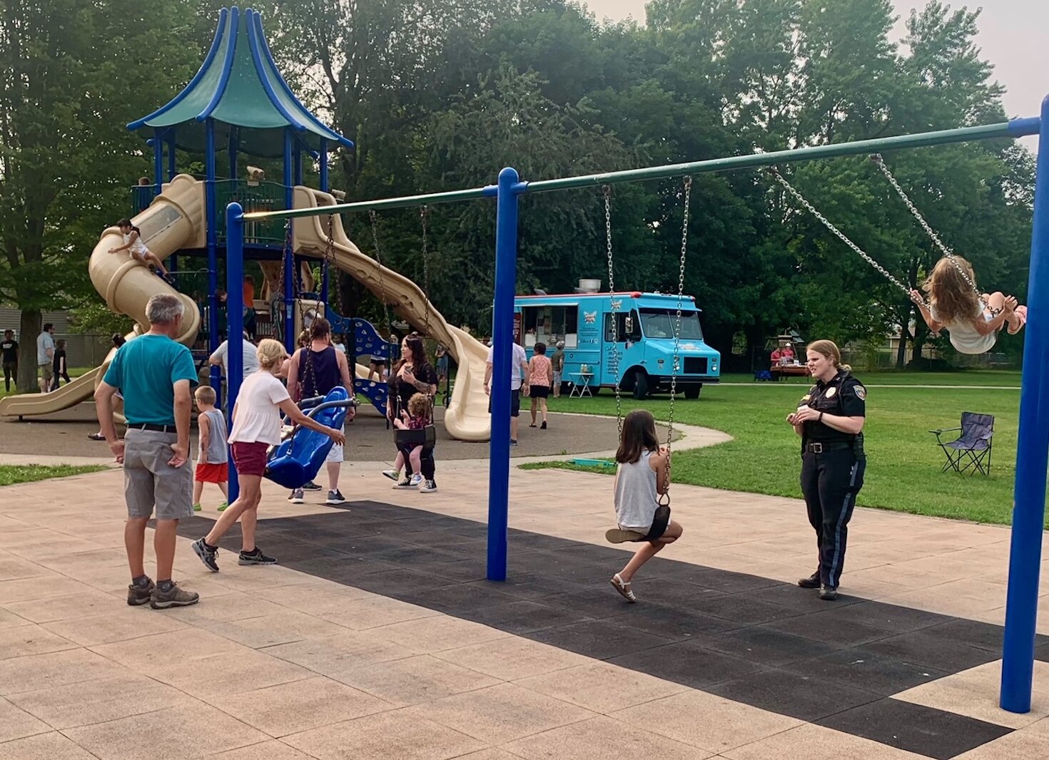 A police officer interacts with families during National Night Out, held Tuesday, Aug. 1, 2023 in Frays Park in Kalamazoo’s Westwood Neighborhood.