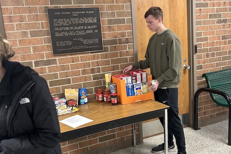 Olivet High School student council students sorting food collected for the food bank