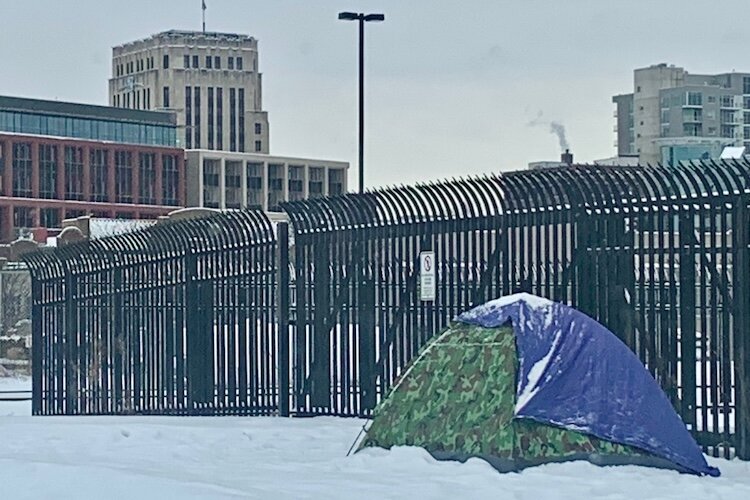 A tent, pitched recently on Pitcher Street just north of Kalamazoo Avenue, is not an uncommon sight as unhoused people brave the weather.