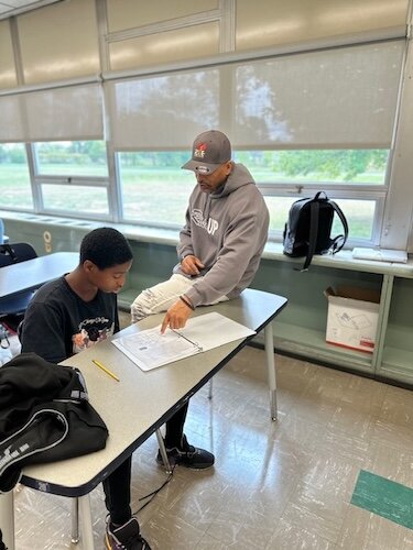 Damon Brown, founder of R.I.S.E., spends some one-on-one time with a youth participant. 