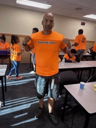  Damon Brown, R.I.S.E. founder, making a point with his "Kids are Bulletproof T-shirt.