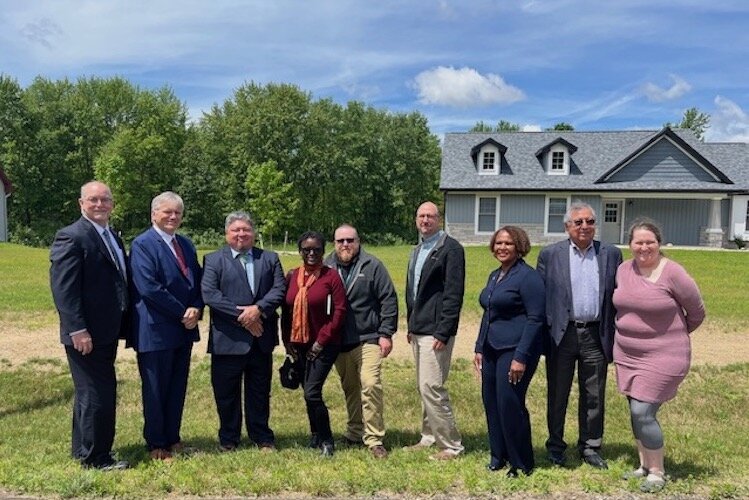 Members with NHBP and HUD pose for a photo on the site of Phase 9. They are from left to right, Jim Cunningham, Richard Monocchio, Neil Whitegull, Tara Cameron, Ben Tenney. Dan Green, Diane Shelly, Elton Jones, and Tonya Walters.