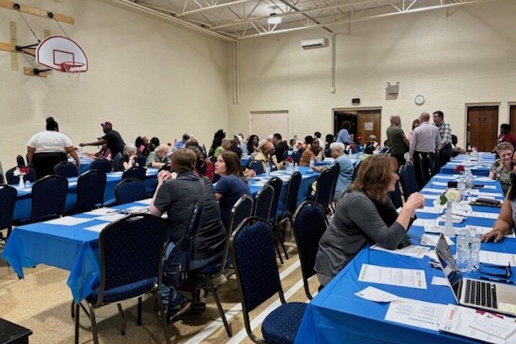 Community residents mingle and talk with another prior to the start of a dinner and discussion, "Building Equity: A Panel Discussion on Housing Justice in Battle Creek," on June 5 at Washington Heights United Methodist Church. 