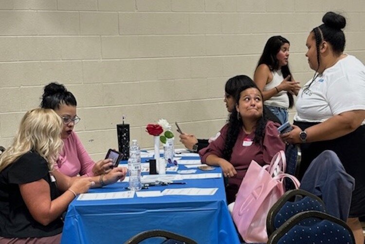 Community residents mingle and talk with another prior to the start of a dinner and discussion, "Building Equity: A Panel Discussion on Housing Justice in Battle Creek," on June 5 at Washington Heights United Methodist Church. 