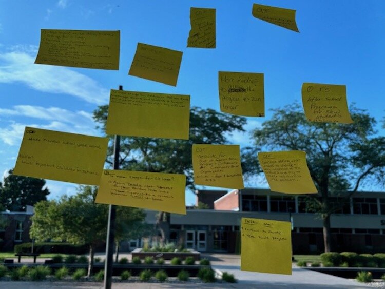 Post-it notes with answers to questions asked during the listening session were attached to windows inside Kellogg Community College's Binda Center for the Performing Arts.