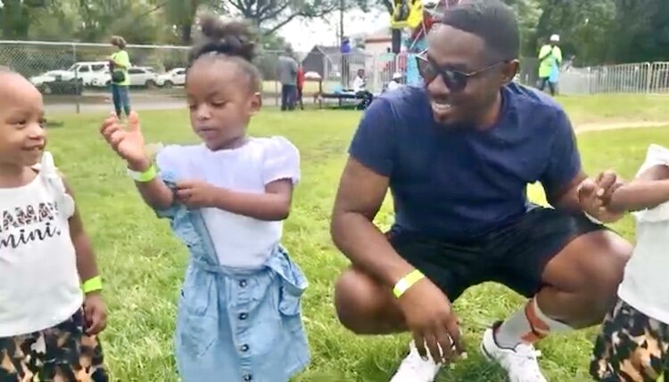 Family fun is to be in focus at the Northside Ministerial Alliance’s 4th Annual Anti-gun Violence Carnival on Aug. 24, 2024. A man is shown with young children at the 2023 event.