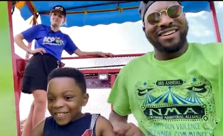 Free family fun life is to be in focus at the Northside Ministerial Alliance’s 4th Annual Anti-gun Violence Carnival on Aug. 24, 2024. A man is shown with young children at the 2023 event.