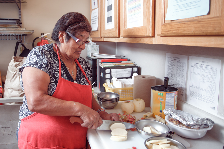 A cook prepares Michigan apples for lunch at the Head Start program in Sparta.  Photo by Autumn Johnson