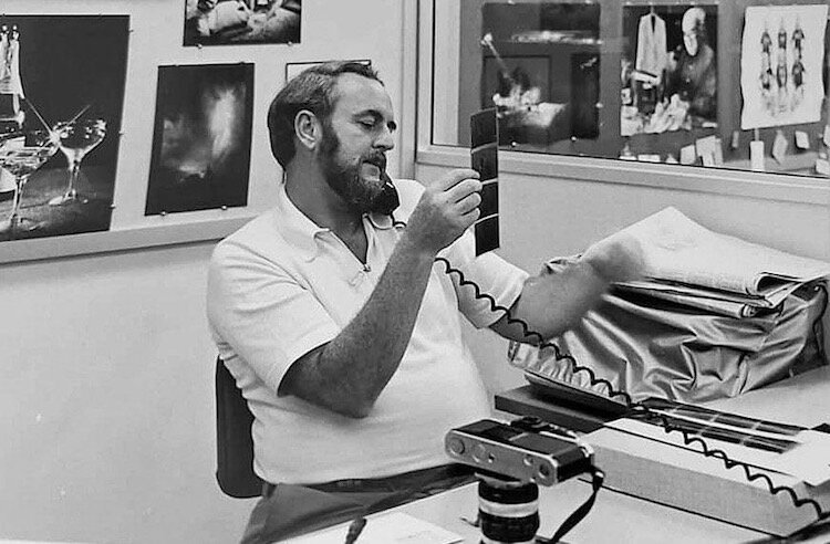 Jerry Campbell is shown editing negatives at his desk in the photo department of the Kalamazoo Gazette.