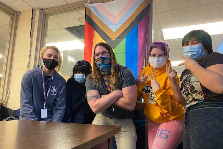 Loy Norrix librarian John Kreider, center, poses for a photo with GSA members Thea Pipe, Destiny Gutter, Alex Bucher, and Jay Michels.