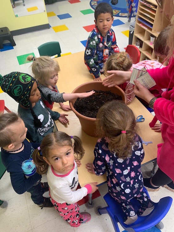 Planting flowers with Ms. Lisa at the Learning Zone,