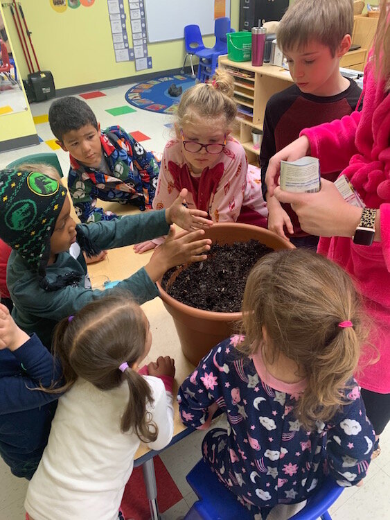 Planting flowers with Ms. Lisa at the Learning Zone,