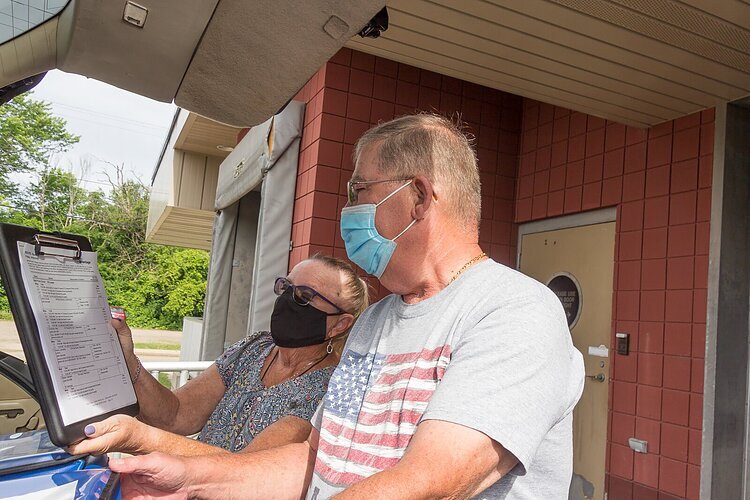 Marcia Hutchins and Jim Geerlings check a delivery list for Senior Services of Southwest Michigan.