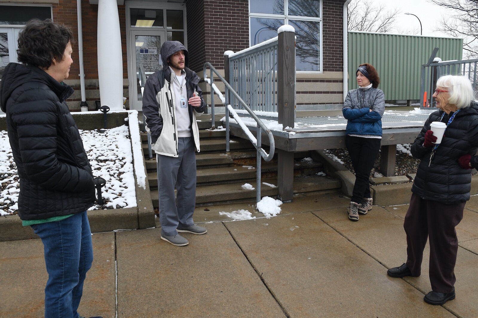 Mark Barber of Senior Services talks with meals on wheels volunteers.