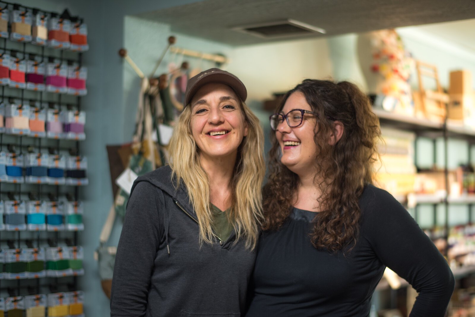 Jennifer Faketty, owner of Confections with Convictions, and sister Rebecca Macleery, owner of Kalamazoo Dry Goods, share a laugh.