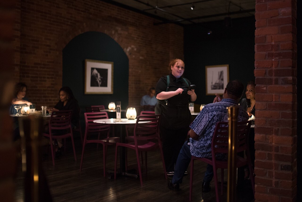 Dabney & Co. is divided into two, with music in the dining room playing to people at tables, and the bar on the other side of a brick wall.