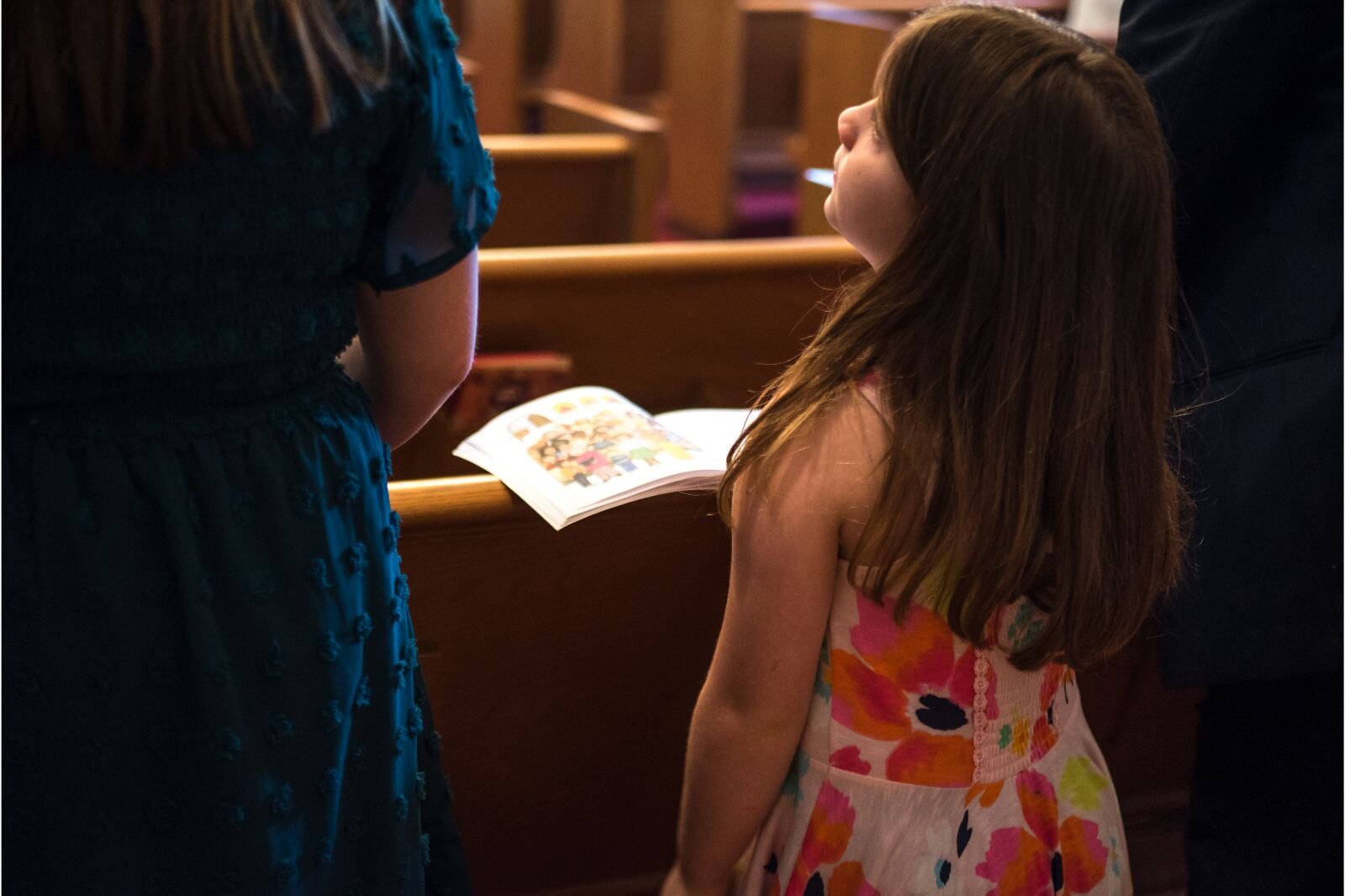 A young member of the church, Amelia Ingalls stands during the service.