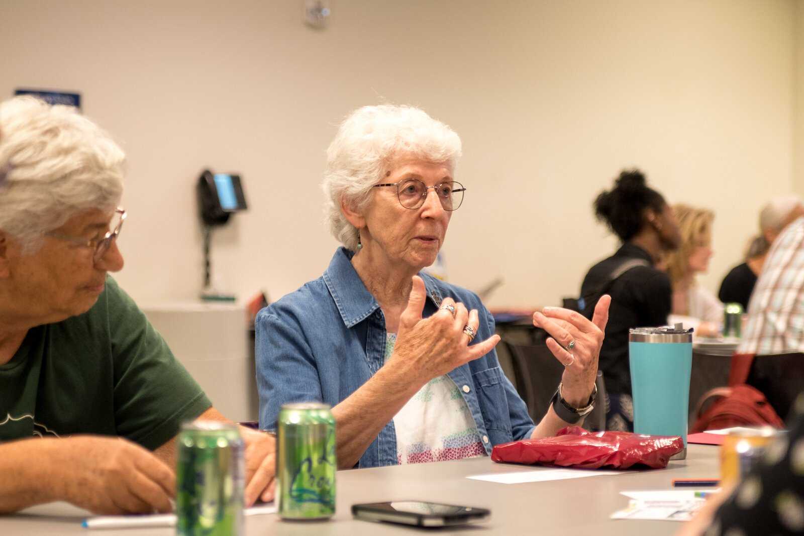 Sister Christine Parks of the Sisters of St. Joseph converses with a table of Kalamazoo Lyceum attendees.