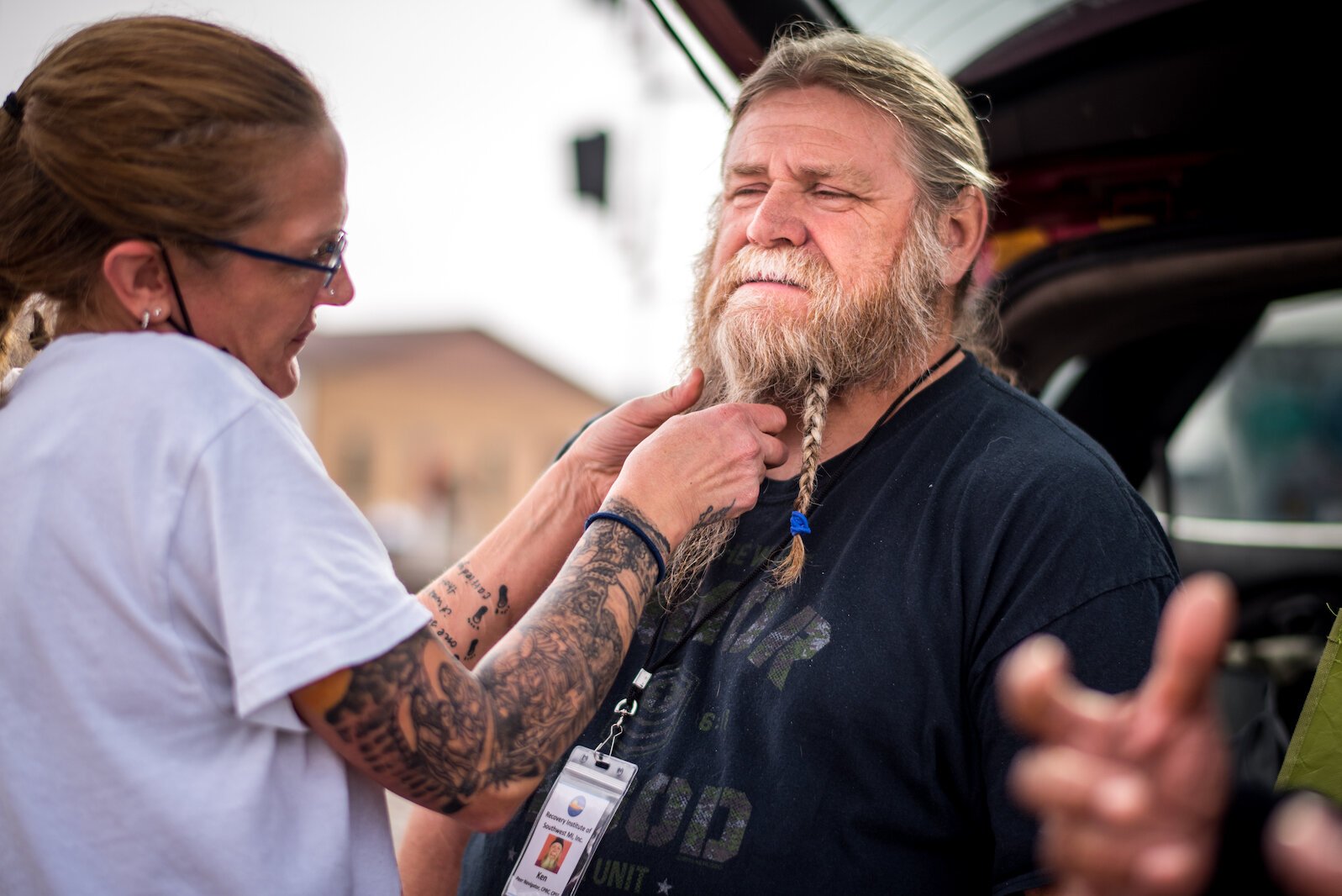 At a recent  open air clinic near there were acts of kindness as a Peer Navigator from Recovery Institute of Southwest Michigan gets his beard braided.