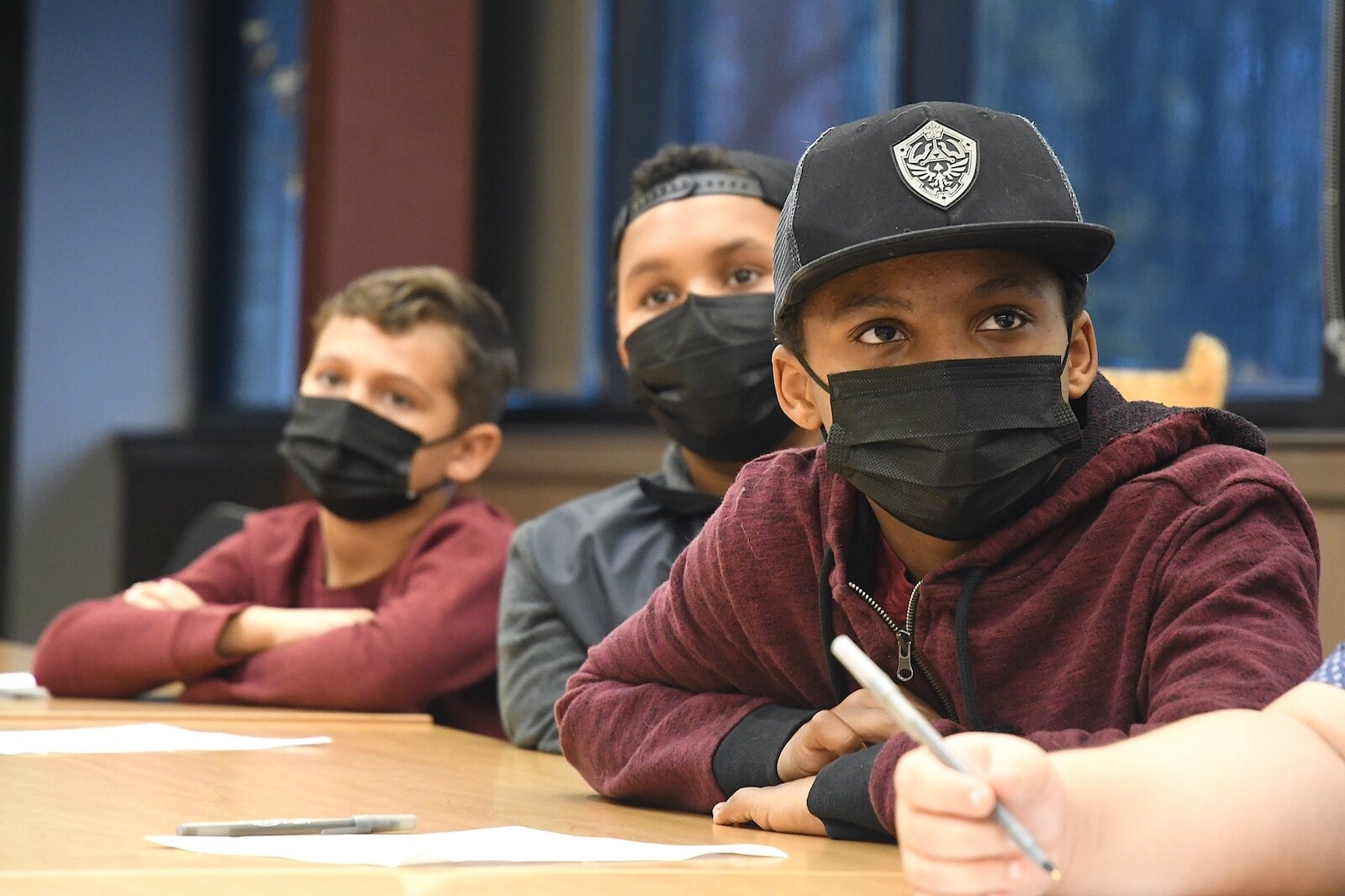 Watching a video of “The Forever Sky” by Thomas Peacock, are Tribal Youth Program members, from left, Emory Ansley, Greyson Moulds and Porter Moulds.