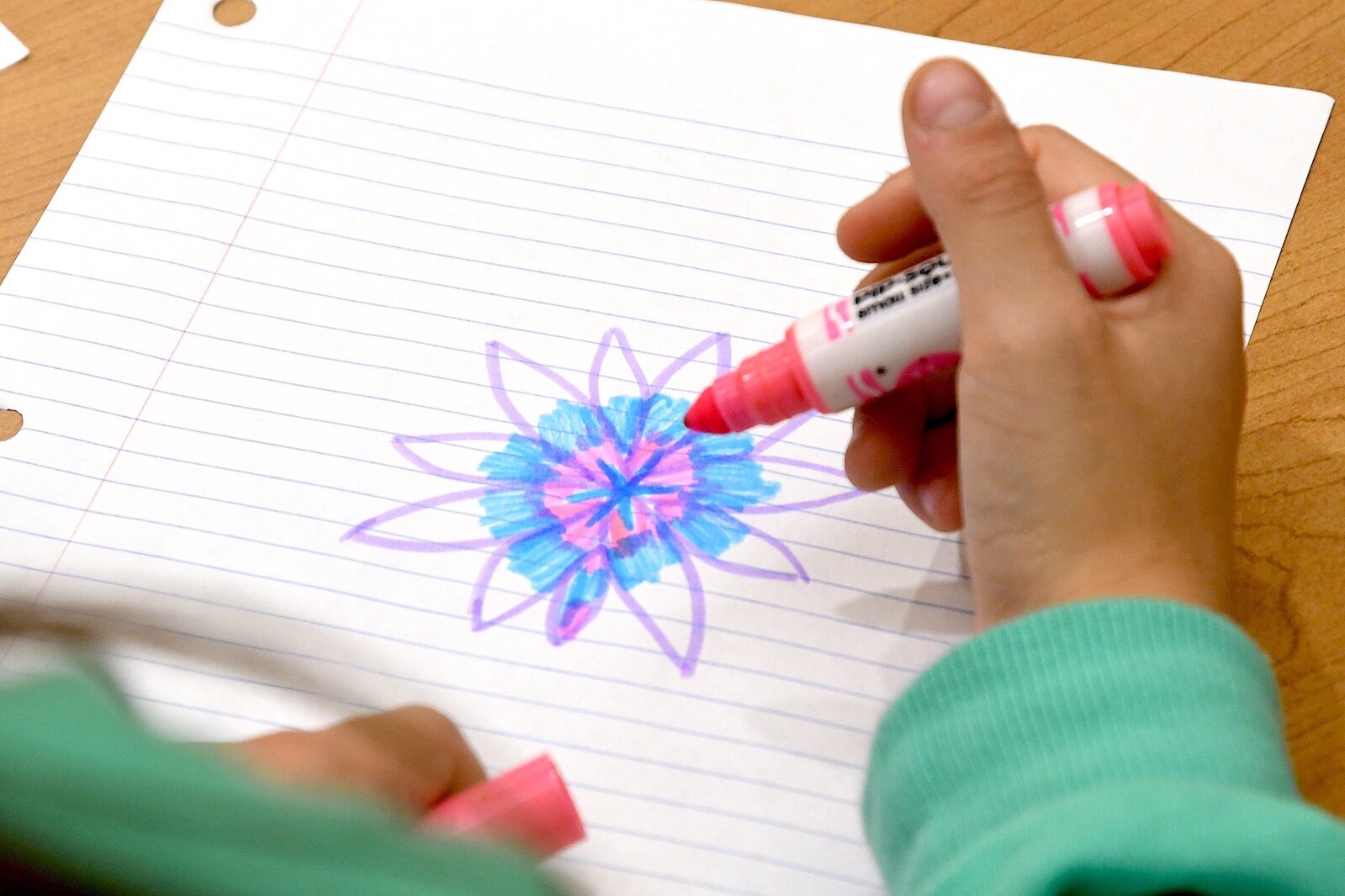 Tribal Youth Program member Kendall Goldner draws a picture while watching a video of “The Forever Sky” by Thomas Peacock.