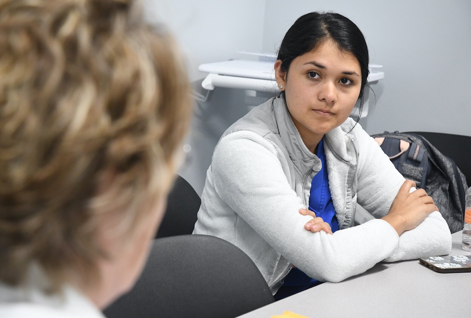 KCC nursing student Vania Martinez listens to Renee Mielke, Ed.D., KCC nursing professor, during a de-briefing session.