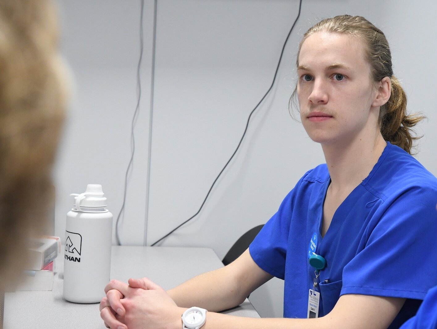 KCC nursing student Caleb Vander Weide listens to Renee Mielke, Ed.D., KCC nursing professor, during a de-briefing session.