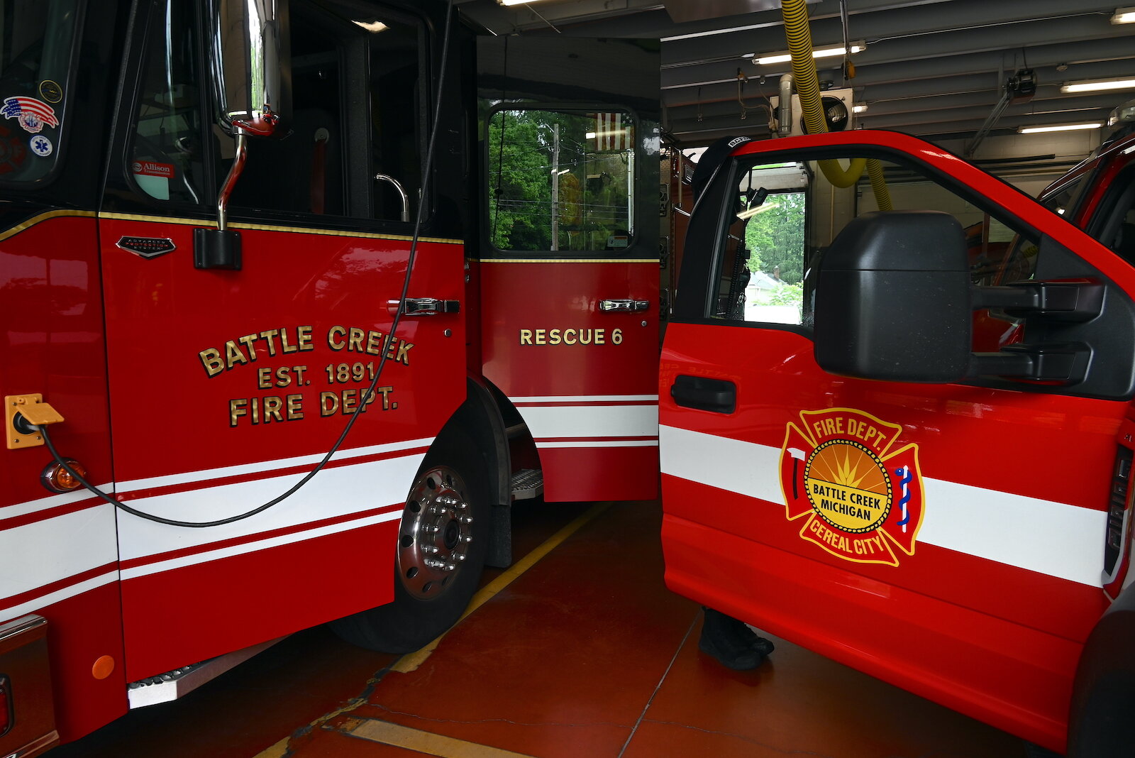 Two fire response vehicles are parked inside Fire Station #6.